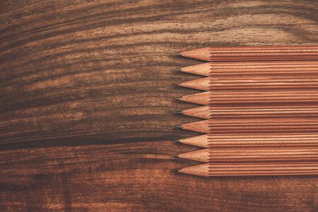 Luxurious charcoal drawing pencils on a wooden tableの写真素材