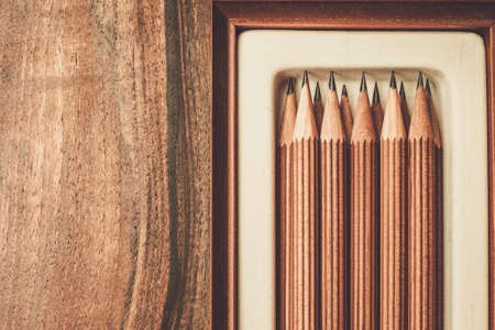 Luxurious charcoal drawing pencils on a wooden tableの写真素材