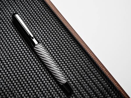 Luxurious rollerball pen on a carbon surfaceの写真素材