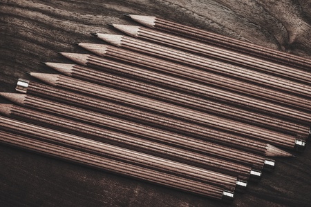 Luxurious charcoal drawing pencils on a wooden tableの写真素材