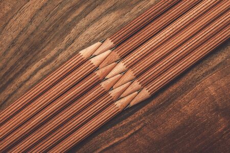 Luxurious charcoal drawing pencils on a wooden tableの写真素材