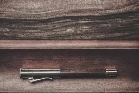 Luxurious rollerball pen on a wooden backgroundの写真素材