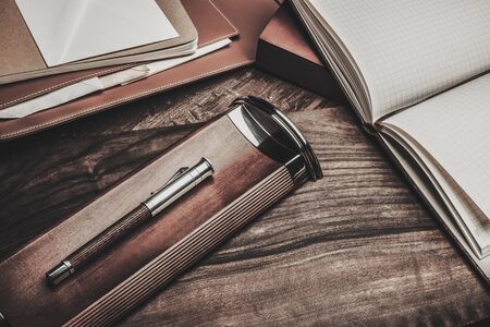 Luxurious writing tools on a wooden table