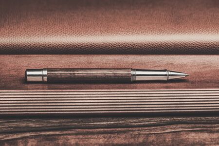 Luxurious rollerball pen on a wooden backgroundの写真素材