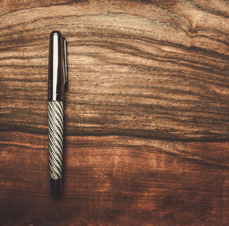 Luxurious rollerball pen on a wooden backgroundの写真素材