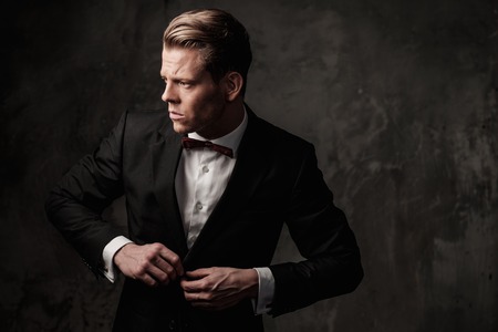 Tough sharp dressed man in black suitの写真素材