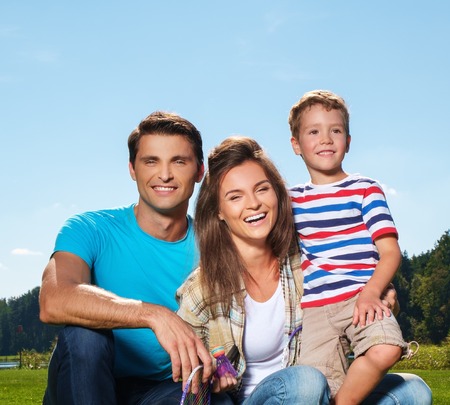 Happy young family with their child outdoorsの写真素材