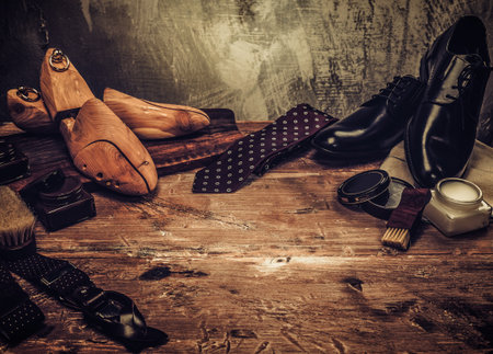 Shoe care and gentleman's accessories on a wooden tableの写真素材