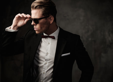 Tough sharp dressed man in black suitの写真素材