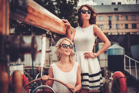 Stylish wealthy women on a luxury yacht