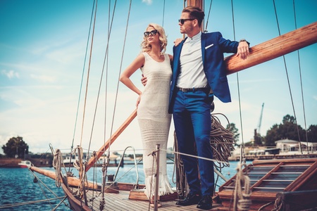 Stylish wealthy couple on a luxury yachtの写真素材