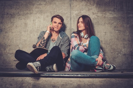 Young couple with skateboard  outdoors