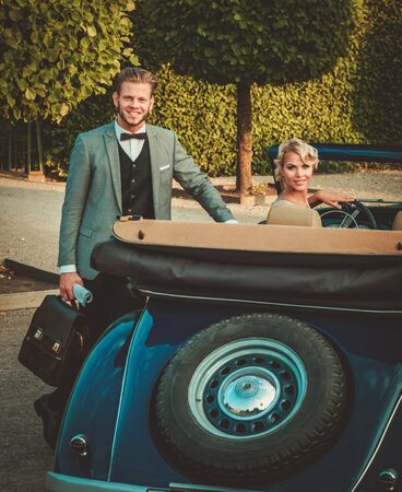 Wealthy couple in a classic convertibleの写真素材