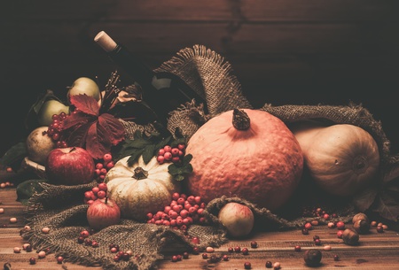 Thanksgiving day autumnal still life with bottle of wineの写真素材