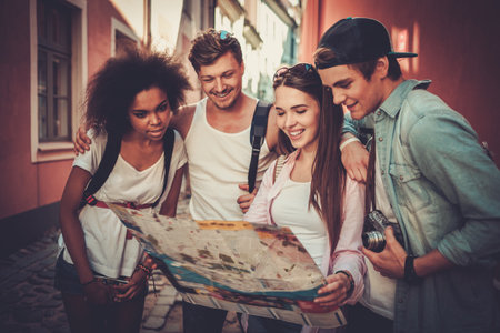 Multiracial friends tourists with map in an old cityの写真素材
