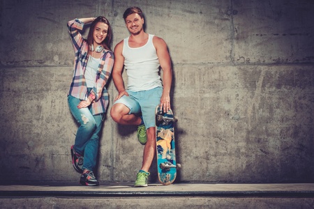 Young couple with skateboard  outdoorsの写真素材