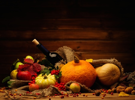 Thanksgiving day autumnal still life with bottle of wineの写真素材