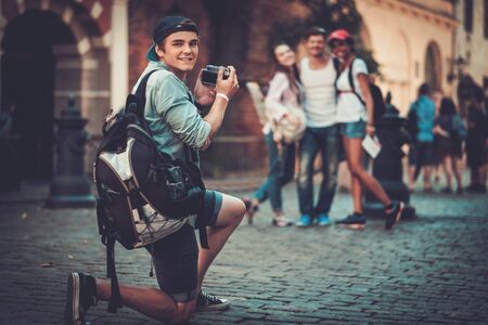 Multiracial friends tourists taking picture in an old cityの写真素材