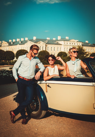 Wealthy friends in a classic convertibleの写真素材