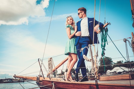 Stylish wealthy couple on a luxury yachtの写真素材