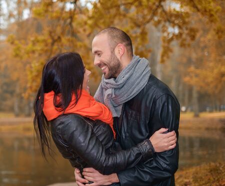 Happy middle-aged couple outdoors on beautiful autumn dayの写真素材