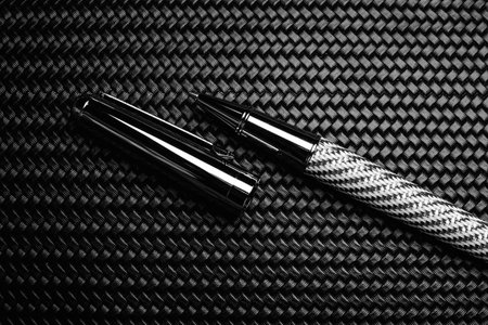 Luxurious rollerball pen on a carbon surfaceの写真素材