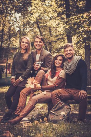 Cheerful friends in autumn parkの写真素材