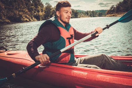 Kayaker with paddle on a boatの写真素材