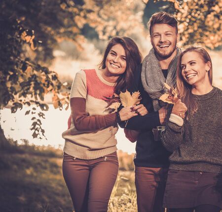 Cheerful friends in autumn parkの写真素材