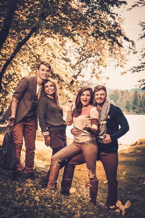 Cheerful friends in autumn park