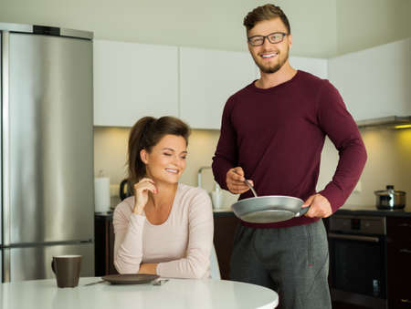 Young family on a kitchen at homeの写真素材