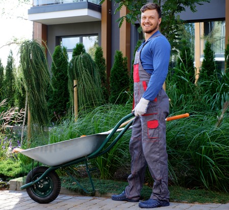 Gardener with tools in gardenの写真素材