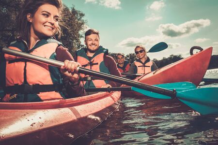 Group of happy people on a kayaksの写真素材
