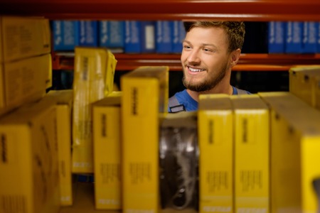 Worker on a automotive spare parts warehouse