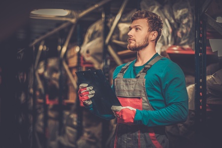 Worker on a automotive spare parts warehouse