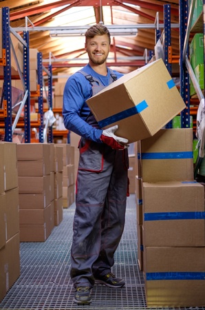 Porter carrying boxes in a warehouse