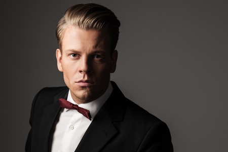 Sharp dressed man wearing jacket and bow tieの写真素材