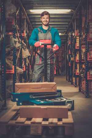 Loader using hand pallet truck in a warehouseの写真素材