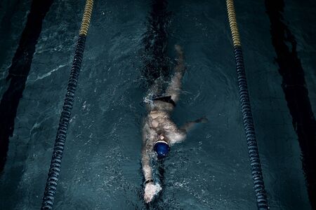 Sportsman swims in a swimming poolの写真素材