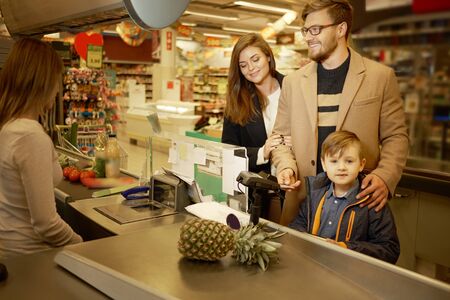 Young family in a grocery storeの写真素材