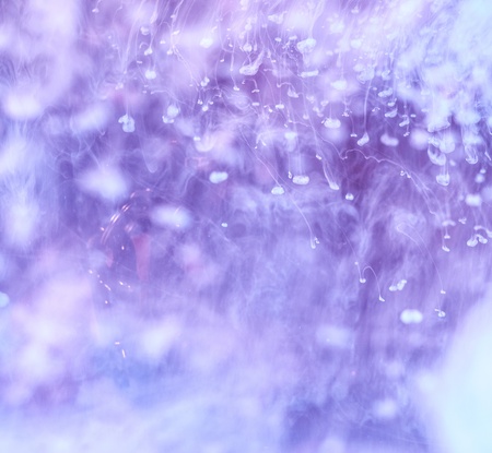 Cloudy purple and white ink in water