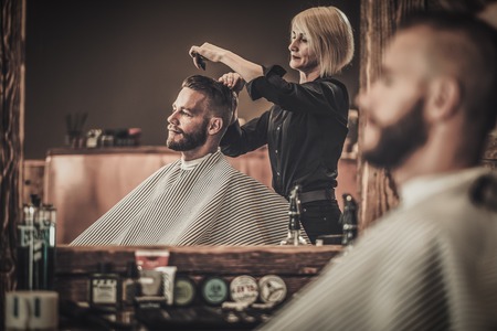 Client visiting hairstylist in barber shop