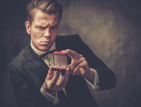 Man holding box with a proposal ring