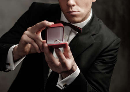 Man holding box with a proposal ring