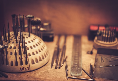 Different goldsmiths tools on the goldsmith workplace.の写真素材