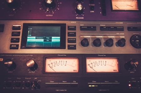 Close-up professional audio equipment with sliders and knobs at boutique recording studio.の写真素材