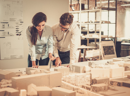 Confident team of engineers working together in a architect studio.