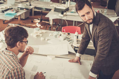 Confident team of engineers working together in a architect studio.