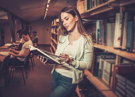 cheerful student studying in the university library.