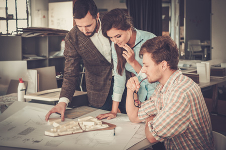Confident team of engineers working together in a architect studio.の写真素材